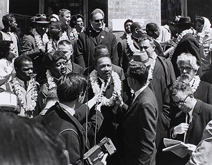Before the march begins, Dr. Martin Luther King, Jr. is joined on the the Brown Chapel steps by John Lewis, Ralph Abernathy, and Rabbi Joshua Heschel, far right.