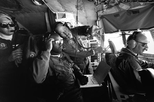 <p>The crew confers on the flight deck of a LC-130 en route to the South Pole Station in one of the season’s 146 scheduled flights.</p><p>"Our morale here is typically pretty high because we’re all so close together, more like a family unit. We are very disappointed that the Navy has decided after 40 years in Antarctica to withdraw. It’s a real strong tradition here. For the most part the flights to the pole are seen as routine flights by the crew. To them it’s just another flight. In fact, we have a saying, ’Rickety rack, to the pole and back’."<br/>—Naval Officer Gary Iverson (far left)</p>