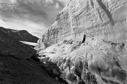 <p>Paul Langevin drills into the Canada Glacier near Lake Hoare.</p><p>“These glaciers are important in the Taylor Valley. We look at the streams flowing from the glaciers and the change of mass of the glacier. When I first came there was a sense of surrealness of the place. All the normal elements I knew like mountains, sun, and glaciers were here. But it’s different, it’s untouched by water so you have features that have been here for hundreds of thousands of years that normally wouldn’t survive. And because there is no vegetation, there is no scale: you don’t know how far away things are.”<br/>—Paul Langevin</p>