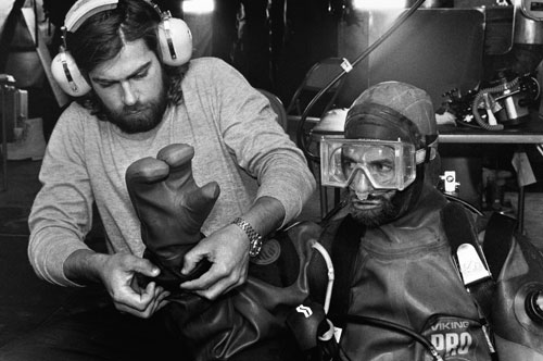 <p>Chris Moeller helps prepare Chuck Amsler, who will descend beneath the ice at New Harbor at McMurdo Sound.</p><p>“Deep sea species live close to the surface here, because the water is cold, just like the deep sea, about 28 degrees F. So that gives us scuba divers access to animals that we would need a submersible to withstand the depths further north. Many of the animals that live in the seabed here are also unusually large, which is a consequence of their slow growth induced by infrequent food availability.”<br/>—Dr. Kathleen Conlan</p>