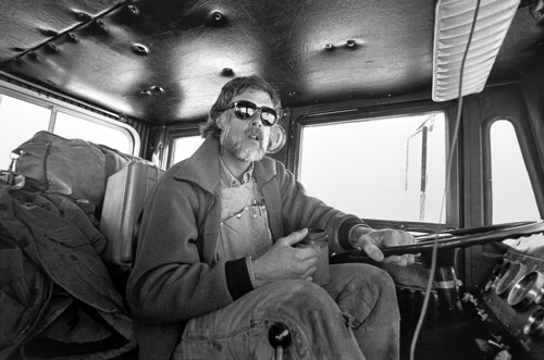 <p>John Wright, leader of a truck convoy, makes a "traverse" over the sea ice 60 miles from McMurdo Station to Marble Point.</p><p>"We come in on Winfly in late August and look at the cracks in the ice and lay out the best routes we can. Then we mark it with flags and program the route on our GPS units. We often get into bad weather out here. Sometimes we don’t even bother to clear the windshields. We just follow the GPS and watch the flags go by."<br/>—John Wright</p>